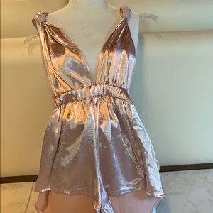 Rose gold romper with tie straps.